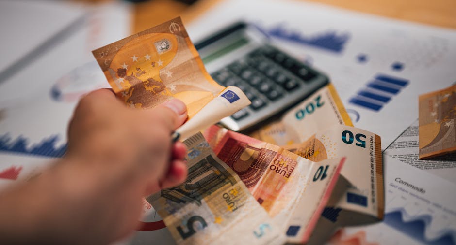 Calculator, pound coins and a notebook on a desk, representing matched betting as a methodical way to make tax-free profit from bookmaker sign-up offers.