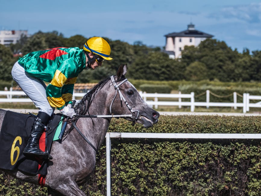 Horses crossing the finish line at a UK racecourse