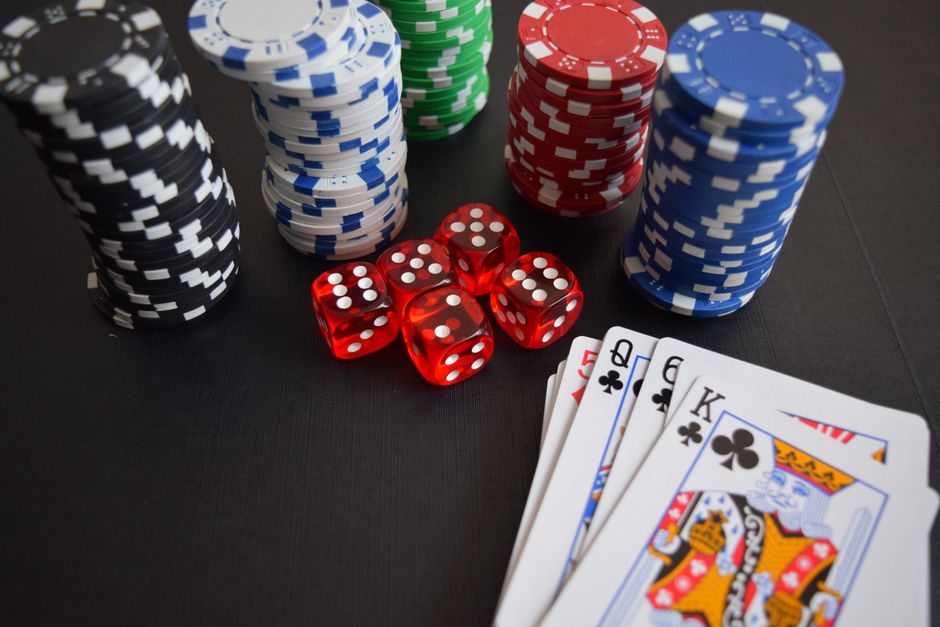 Stack of casino chips on a poker table with dice